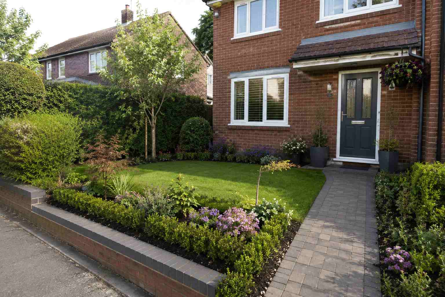 A beautifully landscaped garden with lawn, patio and planted borders in Surrey