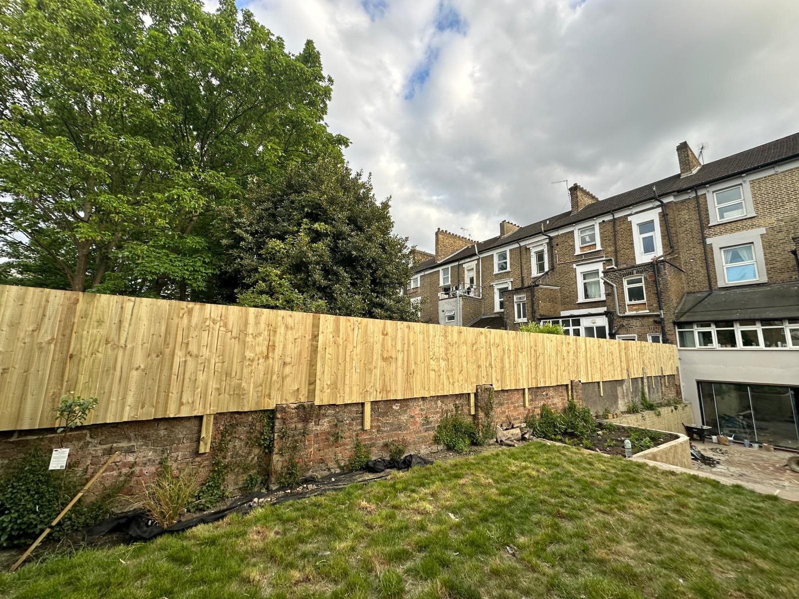 The completed fence run viewed along the boundary