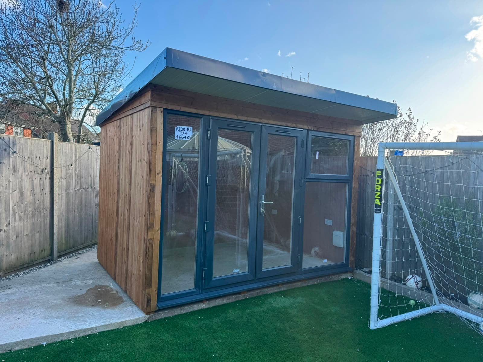 The installed summer house in a Kingswood garden