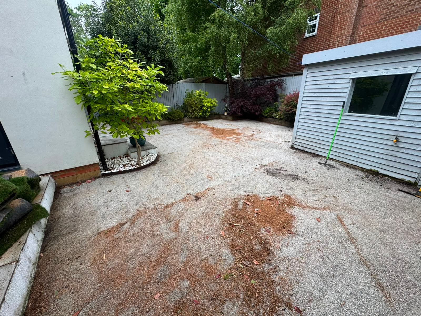 The worn, patchy lawn before the new turf
